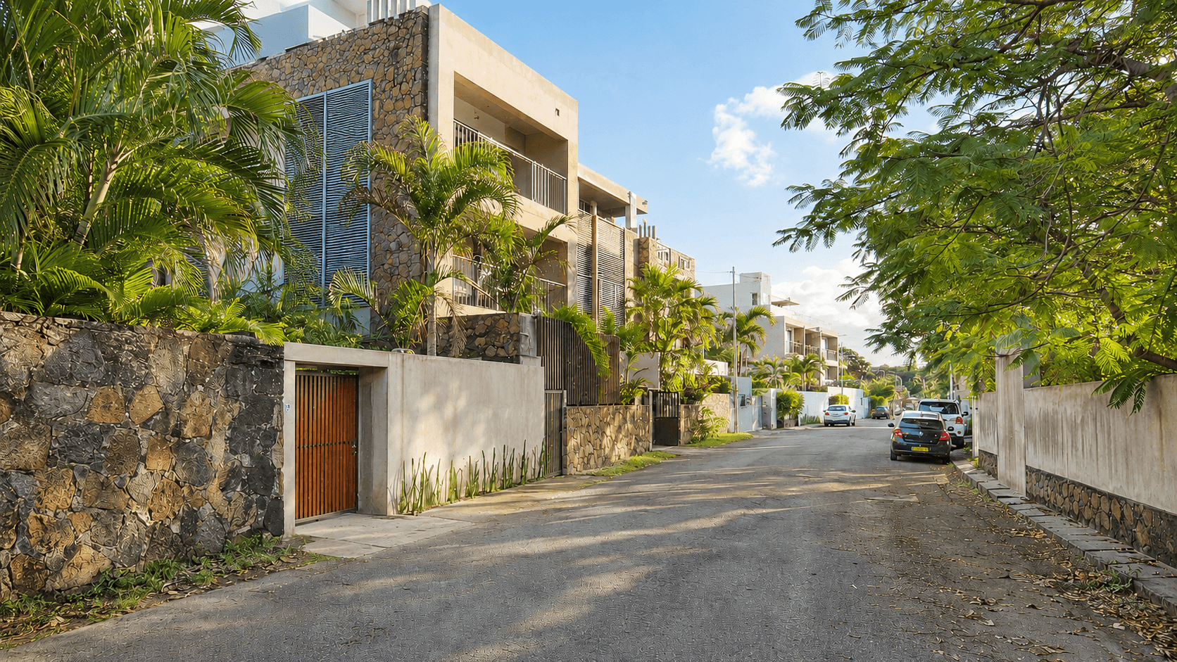 Modern residential street in Mauritius with tropical landscaping and apartments for overseas buyers